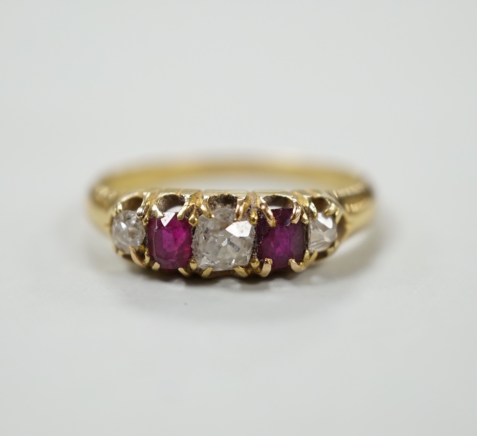 A yellow metal, two stone ruby and three stone diamond set half hoop ring, size J, gross weight 2.2 grams.